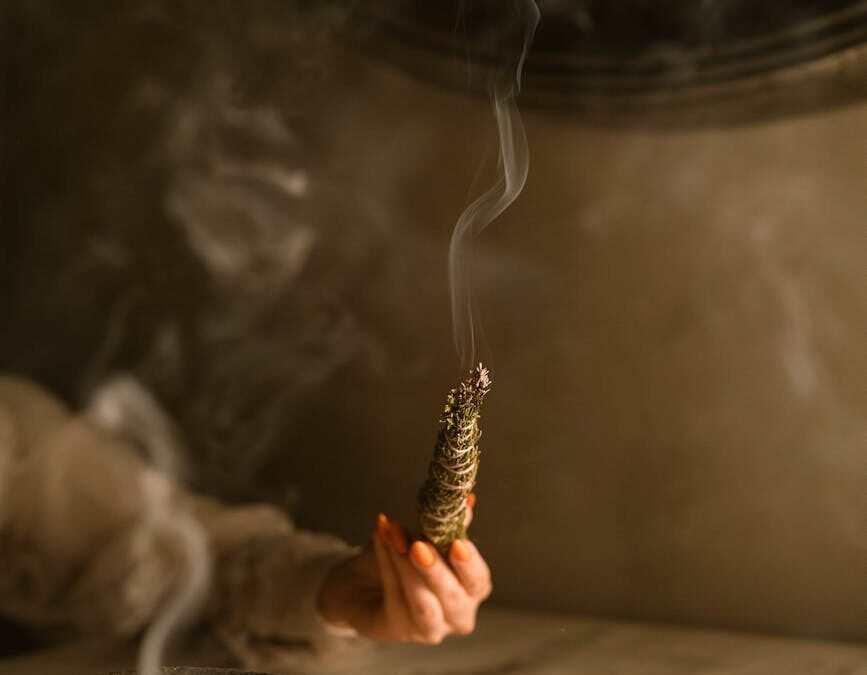 person holding a smoking weed